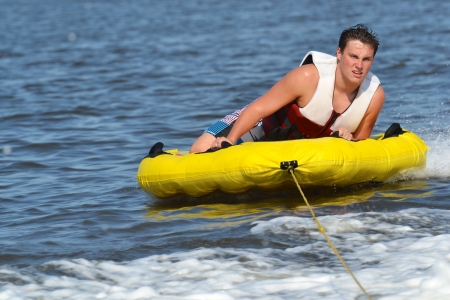Teenage Boy Tubing Getting Ready for His Next Trickの写真素材