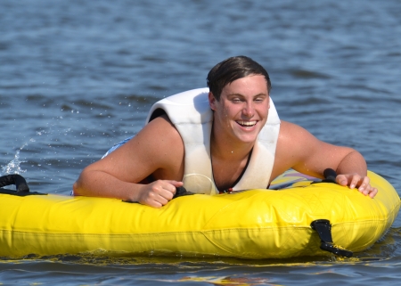 Tubing Fun  Teenage boy having fun laughing before his inner tube ride の写真素材