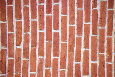 Brick wall vertical / Texture of a wall made of red bricksの写真素材
