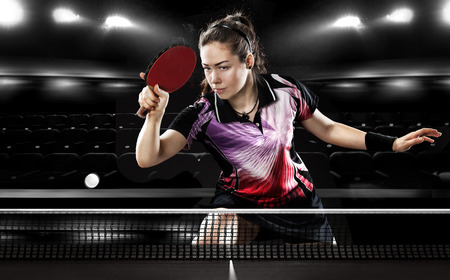 Portrait Of Young Girl Playing Tennis On Black Background with lightsの写真素材