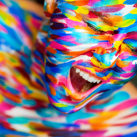 Portrait of the bright beautiful emotional woman with art make-up