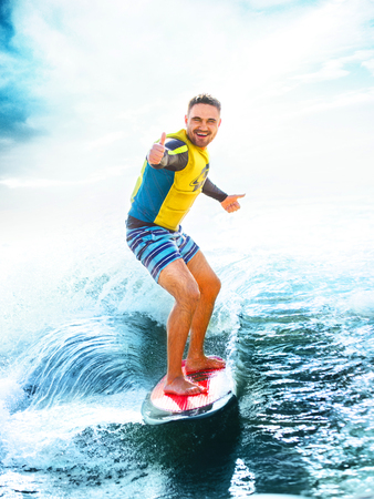 Surfing at Blue ocean. Young Man show thumbs up at wake board. Kite surf outdoor lifestyle.の写真素材