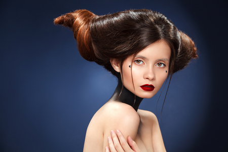 Beautiful girl with a haird in the form of horns. Ads for hairdressers.の写真素材