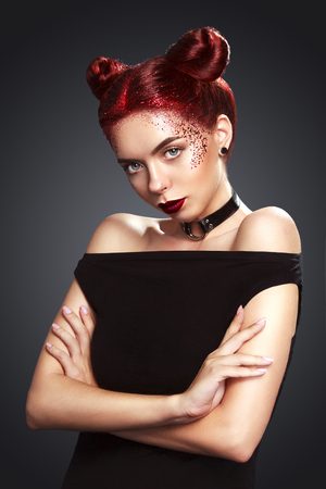 Bright beautiful readhead girl with tinsel and buns hairstyle. Art makup.. Ads for hairdressers and beauty salon.の写真素材