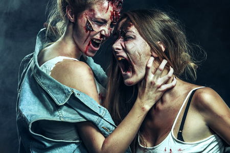 Two Scary zombie women with wounds on Halloween holidays.の写真素材