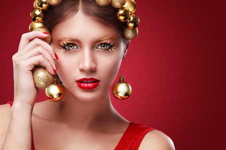 New Year. Young happy woman with gift on bokeh background. Christmas concept.の写真素材