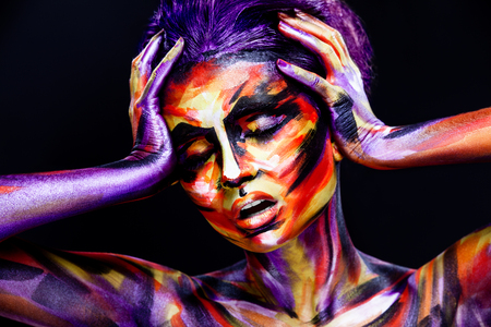 Portrait of the bright beautiful girl with art colorful make-up and bodyartの写真素材