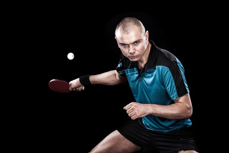 Portrait of sports man, male, athlete playing table tennis isolated on black backgroundの写真素材