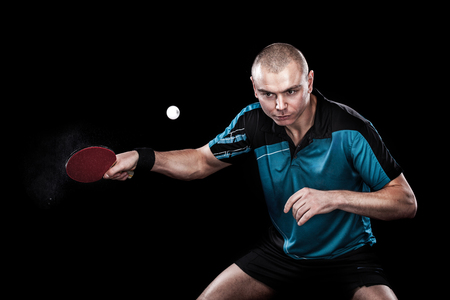Portrait of sports man, male, athlete playing table tennis isolated on black backgroundの写真素材