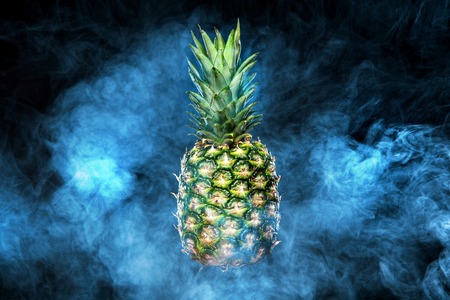 Pineapple fruit on background with vape smokeの写真素材