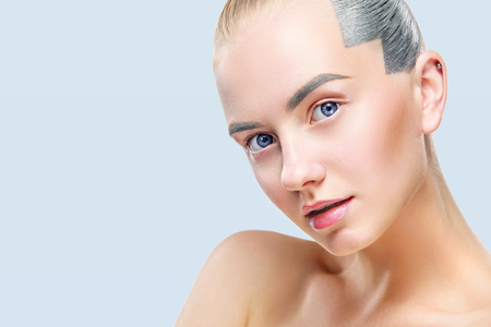 Beautiful blond woman with perfect skin and face. Isolated on blue backgroundの写真素材