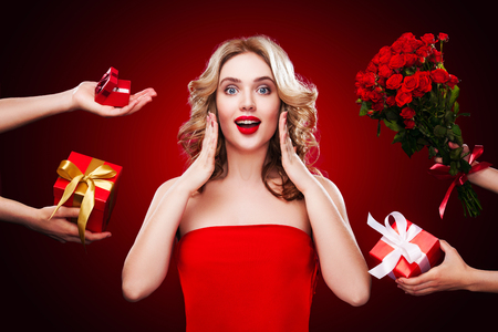 Beautiful blonde woman receive gifts and flowers on saint Valentine and International womens days.の写真素材