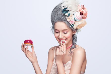 Beautiful blonde woman with a cake. Sweet sexy lady. Vintage style. Fashion photoの写真素材