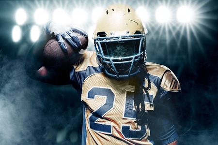 American football sportsman player on stadium running in actionの写真素材