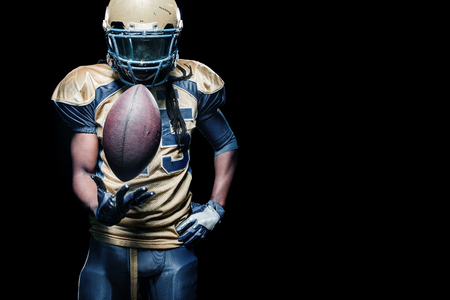 American football sportsman player isolated on black backgroundの写真素材