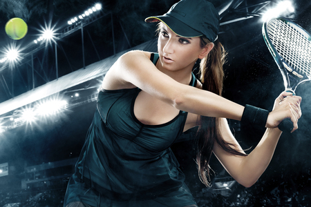 Beautiful sport woman tennis player with racket in blue costumeの写真素材