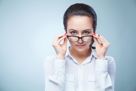woman with glasses on light backgroundの写真素材