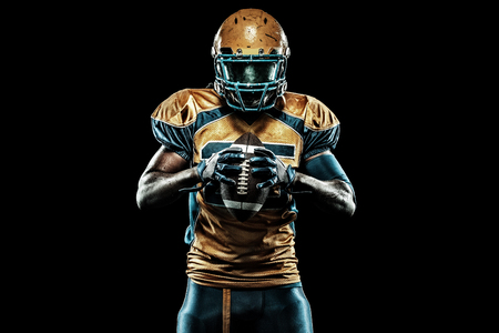 American football sportsman player isolated on black backgroundの写真素材