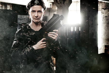 Heavily armed masked lasertag soldier on post apocalyptic background. Ad concept.の写真素材