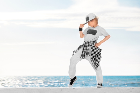 Fashion child dancing over sky background.の写真素材