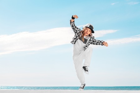 Fashion child dancing over sky background.の写真素材