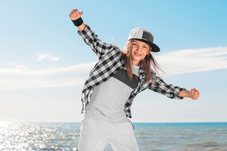 Fashion child dancing over sky background.の写真素材
