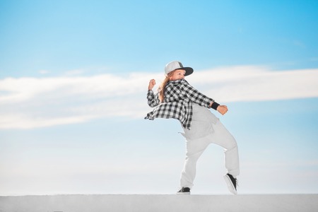 Fashion child dancing over sky background.の写真素材