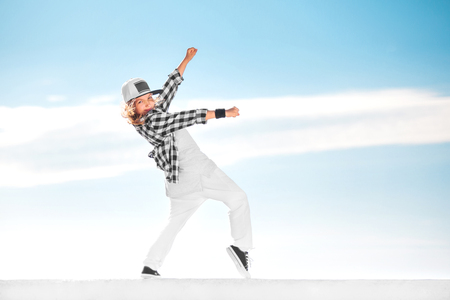 Fashion child dancing over sky background.の写真素材
