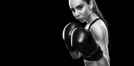 Sportsman muay thai boxer fighting. Isolated on black background. Copy Space.の写真素材