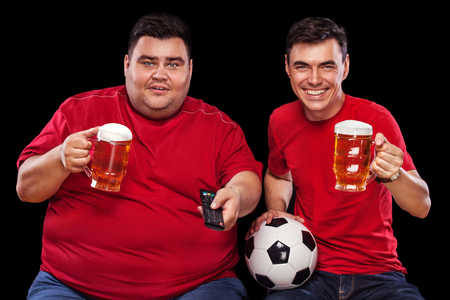 Half-length portrait of young fat man with holding the beer mug Isolated on solid backgroundの写真素材