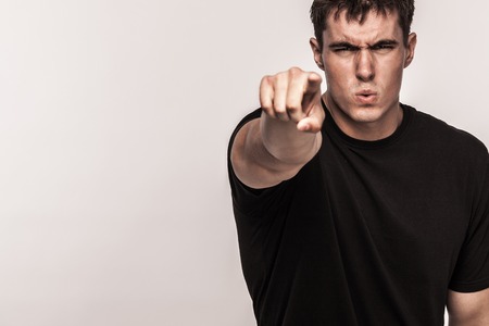 Portrait of fashionable handsome man in black t-shirt. Light background with copy spaceの写真素材