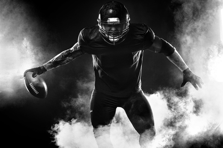 American football sportsman player on stadium. Sports banner and wallpaper with copyspace.の写真素材