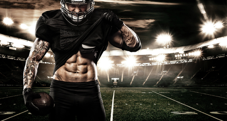 American football sportsman player on stadium. Sports banner and wallpaper with copyspace.の写真素材