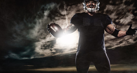 American football sportsman player over sky background. Sports banner and wallpaper with copyspace.