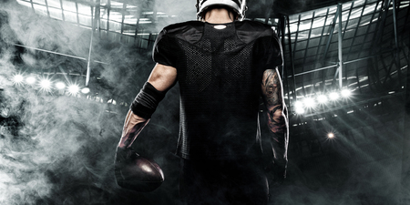 American football sportsman player on stadium. Sports banner and wallpaper with copyspace.の写真素材