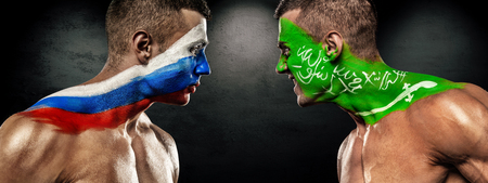 Russia vs Saudi Arabia. Two soccer or football fans with flags face to face.. World Cup 2018.の写真素材