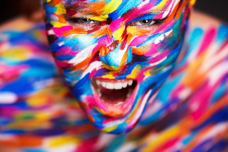 Portrait of the bright beautiful girl with art colorful make-up and bodyartの写真素材