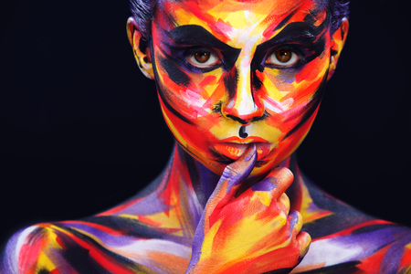 Portrait of the bright beautiful girl with art colorful make-up and bodyartの写真素材