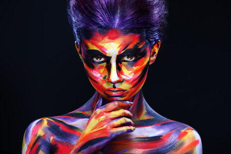 Portrait of the bright beautiful girl with art colorful make-up and bodyartの写真素材