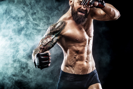 Sportsman boxer fighting on black background with smoke. Copy Space. Boxing sport concept.の写真素材