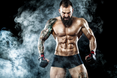 Sportsman boxer fighting on black background with smoke. Copy Space. Boxing sport concept.の写真素材
