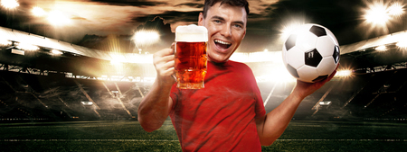 England or Russian football sports fun - happy man at oktoberfest, taking beer and soccer ball on stadium.の写真素材