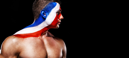 Soccer or football fan with bodyart on face with agression - flag of France.の写真素材