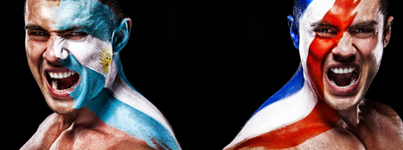 Soccer or football fan with bodyart on face with agression - flag of France vs Argentina.の写真素材