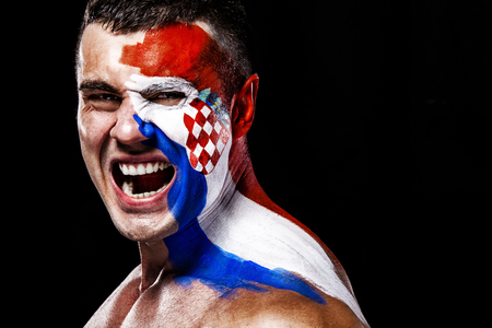 Soccer or football fan with bodyart on face with agression - flag of Croatia.の写真素材