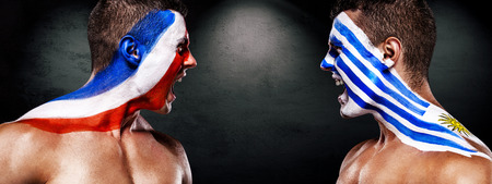 Soccer or football fan with bodyart on face - flags of Uruguay vs France. Sport Concept with copyspace.の写真素材