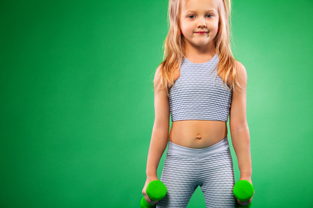 Kid doing fitness exercises at home in her roomの写真素材