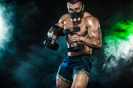 Athletic young sports man - fitness model with barbell.の写真素材