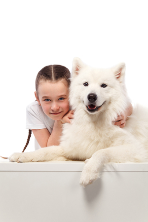 Happy child with dog. Portrait girl with pet. Jack Russell licks a teenの写真素材