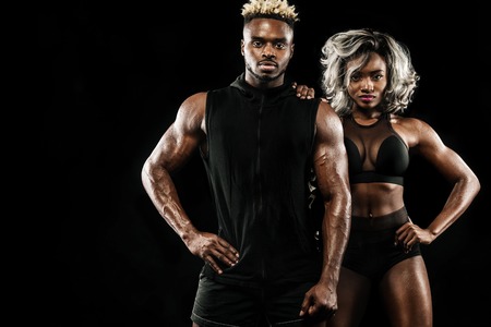 Young attractive couple practicing workout, healthy lifestyle body careの写真素材